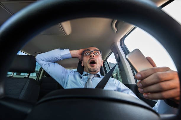 A confused distracted driver about to crash his vehicle